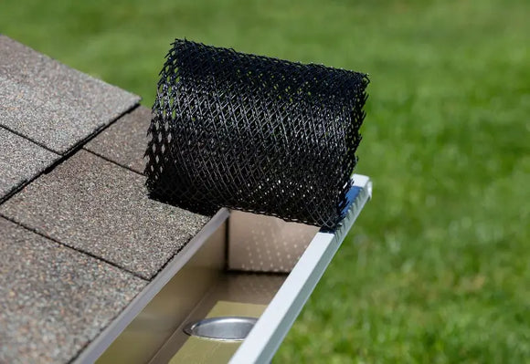 House with mesh gutter guards being installed in MA.