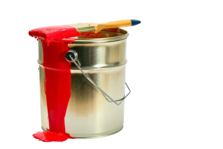 Open paint can with red paint